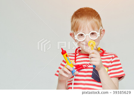 Mischievous boy playing doctor. Toy syringe 39385629