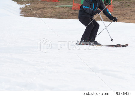 Skiers and snowboarders riding on a ski slope Skiers and snowboarders riding on a ski slope 39386433