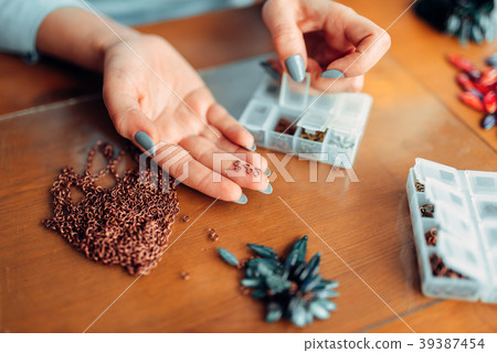 Female hands holds little metal rings, needlework Female hands holds little metal rings, needlework 39387454