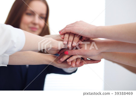 Close Up of unknown business people joining hands Close Up of unknown business people joining hands 39388469