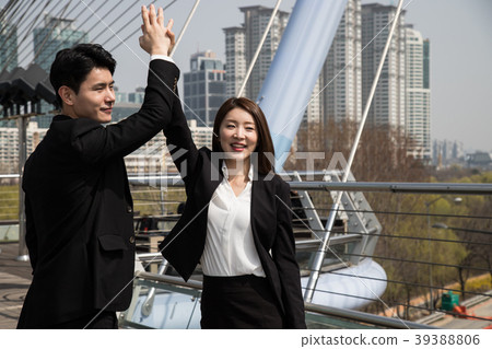 High five of a young man and a woman in a suit High five of a young man and a woman in a suit 39388806