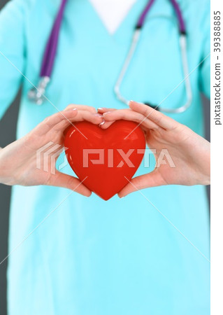 Female doctor with stethoscope holding heart in Female doctor with stethoscope holding heart in 39388885