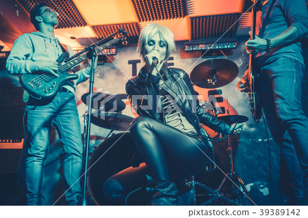 Band playing on stage making music Band playing on stage making music 39389142