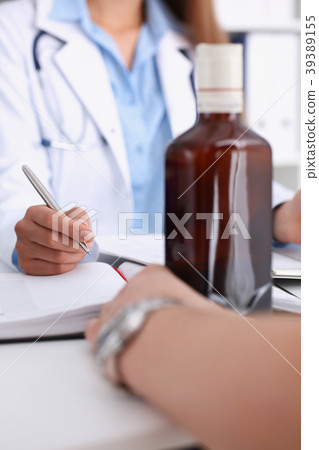 Alcoholic hold in arm empty bottle at doctor Alcoholic hold in arm empty bottle at doctor 39389155