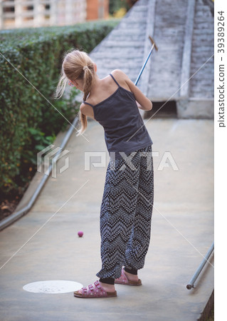 Happy little girl  playing mini golf. 39389264