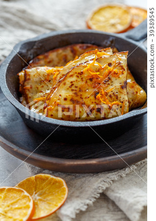 Crepe suzette with orange sauce. 39389545