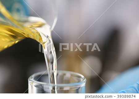 Male hands in protective gloves hold test tube Male hands in protective gloves hold test tube 39389874