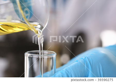 Male hands in protective gloves hold test tube 39390275