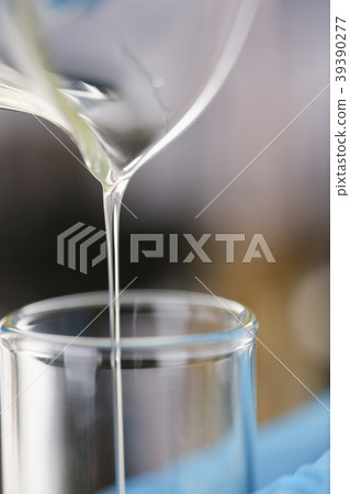 Male hands in protective gloves hold test tube 39390277