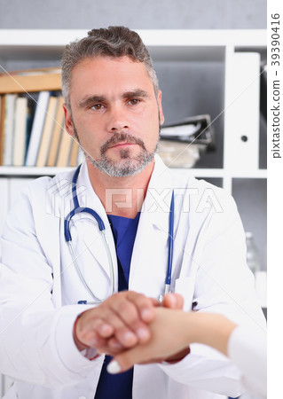 Friendly male doctor hold female arm Friendly male doctor hold female arm 39390416