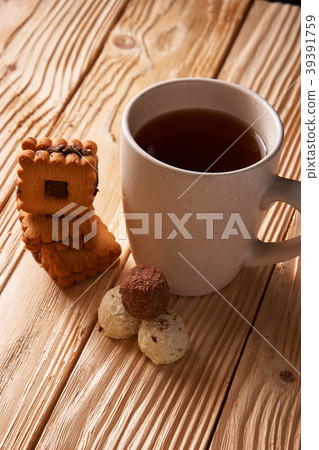 tee and cookies on a wooden table 39391759