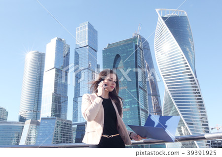 Businesswoman at skyscraper background Businesswoman at skyscraper background 39391925