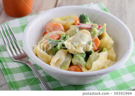 Tortellini with vegetables under cream sauce 39391994