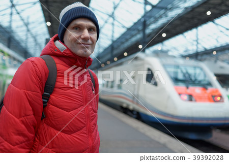 Man on a train station platform 39392028