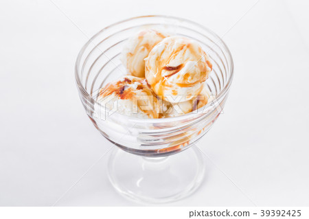 Vanilla ice cream with caramel syrup on white Vanilla ice cream with caramel syrup on white 39392425