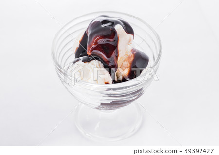 Vanilla ice cream with chocolate syrup on white Vanilla ice cream with chocolate syrup on white 39392427