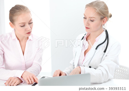 Doctor and patient during personal consulting in Doctor and patient during personal consulting in 39393311