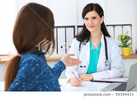 Beautiful female doctor and patient having a talk 39394431