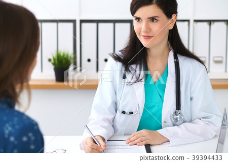 Beautiful female doctor and patient having a talk 39394433