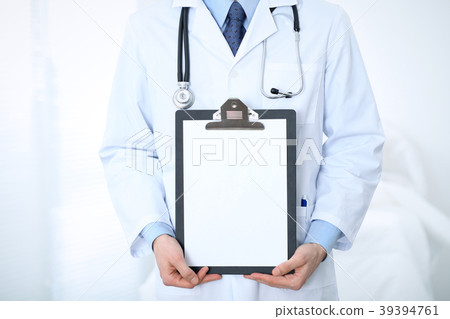 Unknown male doctor standing straight while 39394761