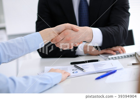 Close Up of unknown business people shaking hands Close Up of unknown business people shaking hands 39394904