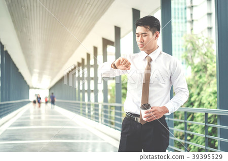 Businessman looking at watch he looks on the time 39395529