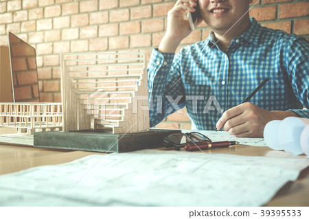Architect or engineer using smart phone working Architect or engineer using smart phone working 39395533