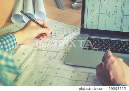 Architect or engineer working in office blueprint Architect or engineer working in office blueprint 39395535