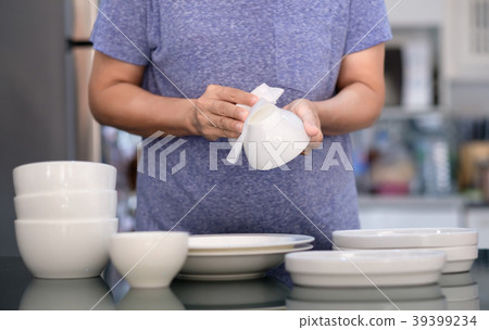 Woman Cleaning product concept wiping dishware 39399234