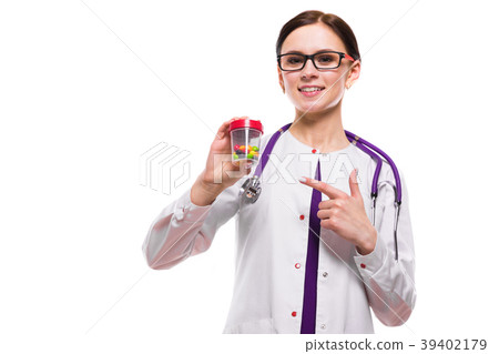 Young beautiful female doctor holding bottle of 39402179