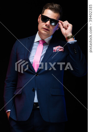 Portrait of confident handsome businessman holding 39402385