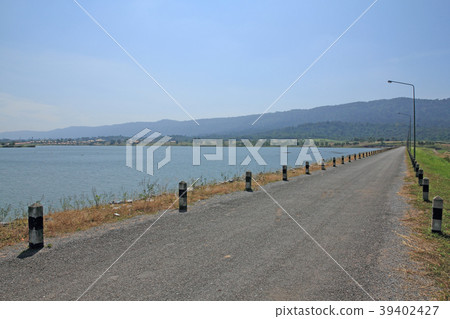 local road beside a dam in mountain 39402427