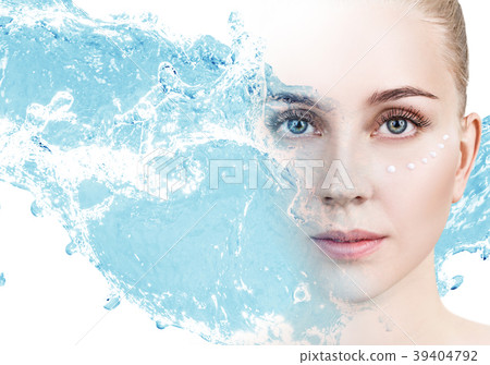Woman with cream dots on face in blue water splash 39404792