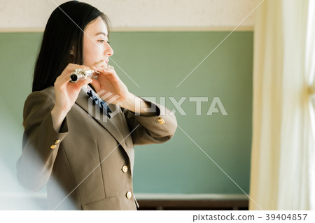 Female student blowing a flute 39404857