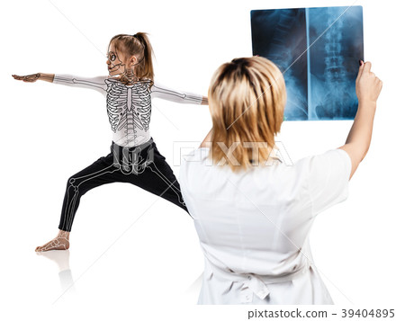 Female doctor looks on x-ray of little girl in Female doctor looks on x-ray of little girl in 39404895