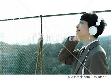 Male student listening to music on the roof 39405469
