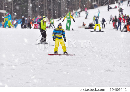 Young man on snowboard downhill Young man on snowboard downhill 39406441