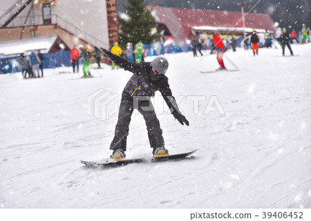 Young man on snowboard downhill Young man on snowboard downhill 39406452