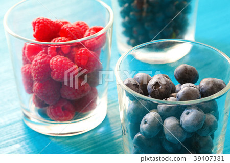 row of wild berries in bowls on wooden background row of wild berries in bowls on wooden background 39407381