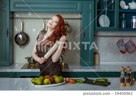 Red-haired woman holds a rolling pin. 39408962