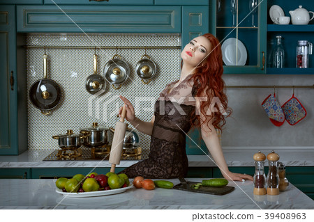 Portrait of a red-haired woman in the kitchen. Portrait of a red-haired woman in the kitchen. 39408963