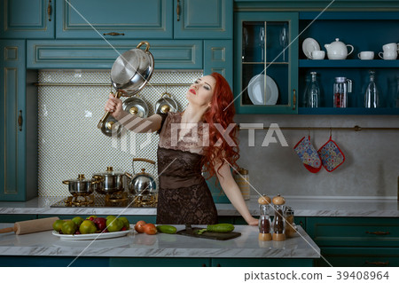 Red-haired woman holds a frying pan. 39408964