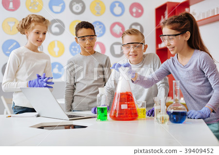 Group of schoolchildren watching chemical reaction Group of schoolchildren watching chemical reaction 39409452