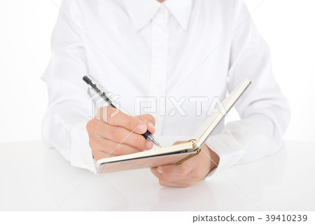 Female hand taking notes with a ballpoint Female hand taking notes with a ballpoint 39410239