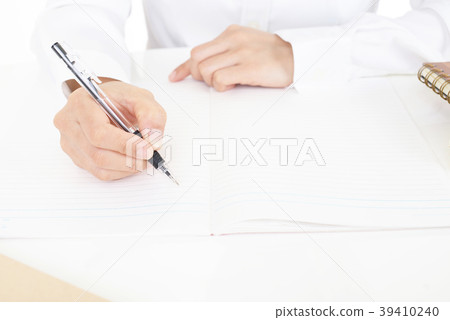 Female hand taking notes with a ballpoint Female hand taking notes with a ballpoint 39410240