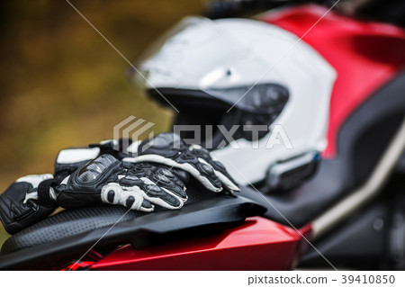 Biker sitting on motorcycle on an empty road Biker sitting on motorcycle on an empty road 39410850