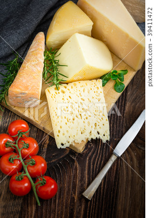 Cheeses with basil, rosemary and tomatoes. 39411472