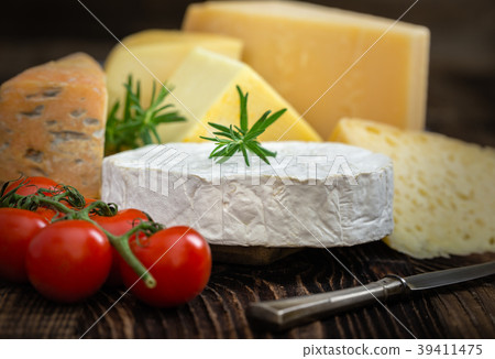 Cheeses with basil, rosemary and tomatoes. 39411475