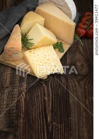 Cheeses with basil, rosemary and tomatoes. 39411477