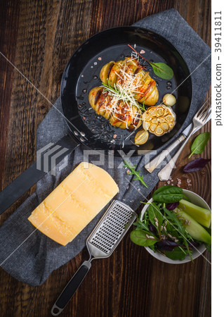 Baked hasselback potatoes. 39411811